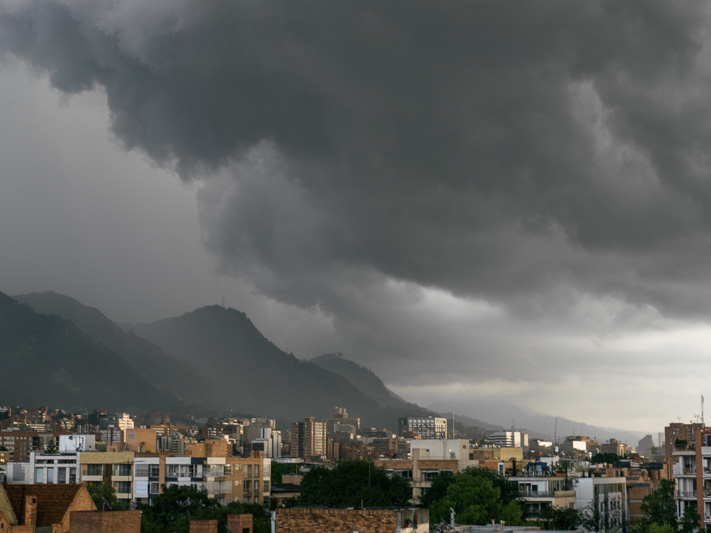 Photo Typical Bogotá afternoon weather. Police riot vans move in to break up a demonstration in the capital. 