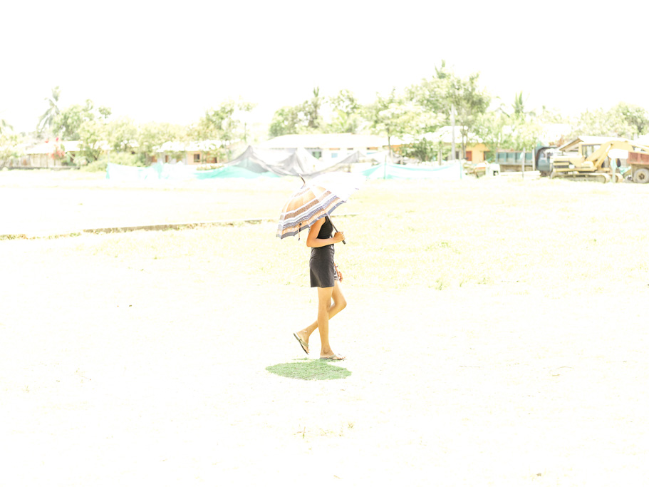 Photo A girl in Nechí, Antioquia walks in the midday sun. Right, former Miss Colombia and 1991 Miss Universe runner-up, Paola Turbay, poses during photo-shoot. 