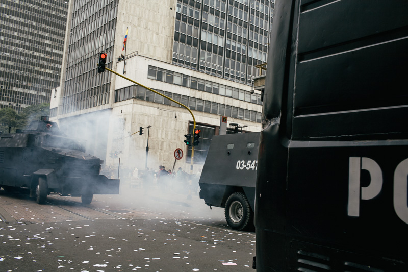 Photo Typical Bogotá afternoon weather. Police riot vans move in to break up a demonstration in the capital. 